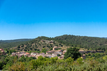Fototapeta premium The Spanish village of Aguas Candidas nestled in a green valley, Burgos.