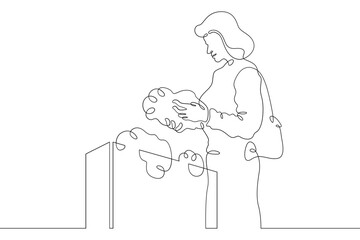 Continuous one line drawing woman chooses food products in a store.One continuous line isolated minimal illustration.Not AI.