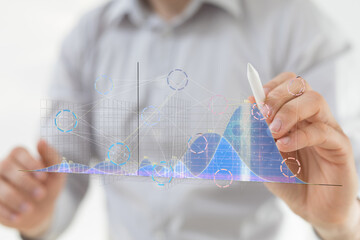 Stock photo of a businessman analyzing data charts and graphs. Perfect for business, finance, and technology concepts.