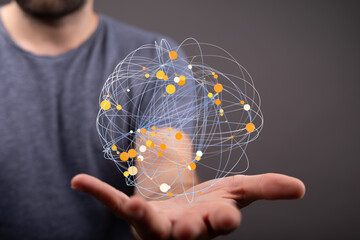 A man holds a digital sphere representing global interconnectedness. Network, technology, connection concept.
