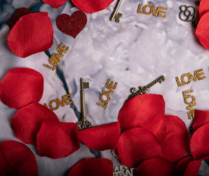 Romantic Background with Red Petals and the Word LOVE &ndash; Valentine's Day Template,
