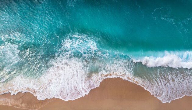 aerial view of turquoise ocean waves crashing on sandy beach
