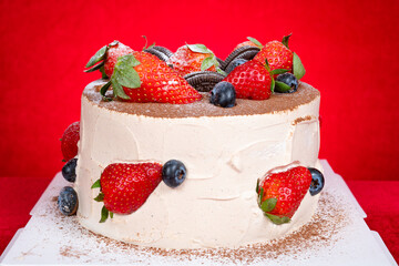 angle view birthday cake with fruits and crackers at horizontal composition