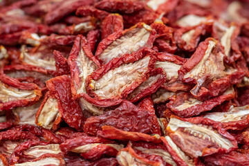 Sun-dried tomatoes in a basket in a street food market, close up. Ripe tomatoes lose most of their water content after spending a majority of their drying time in the sun