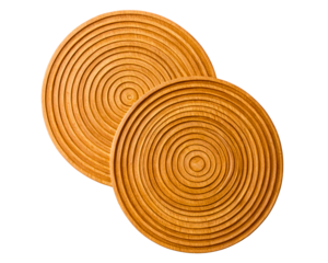 Two round wooden trivets with carved concentric circle patterns on a transparent background
