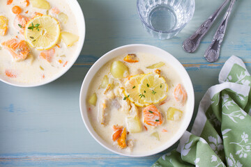 Thick soup chowder made with salmon, white fish, shrimps and vegetables. High angle view