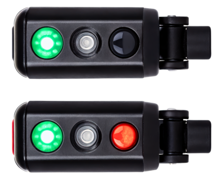 Pair of electronic safety sensors with red and green lights on a transparent background