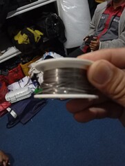 A roll of tinol soldering in hand