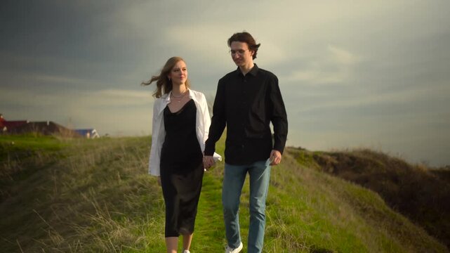 lovely couple is walking hand in hand on beautiful