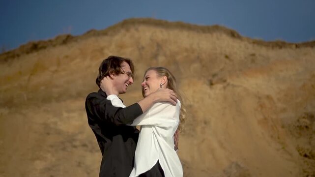 a romantic couple embracing each other outdoors