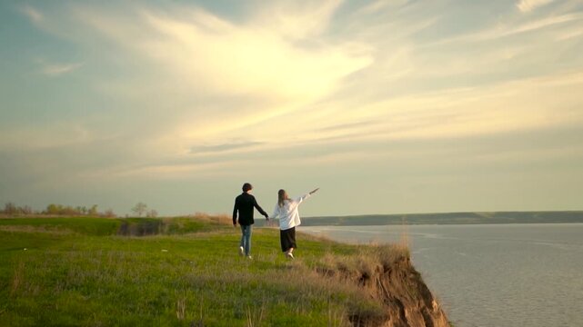a couple walking hand in hand together along