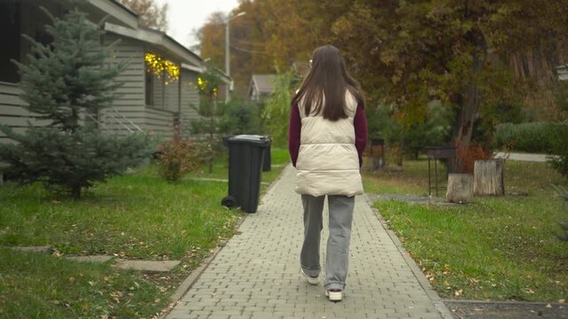 young woman strolls gracefully through