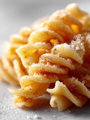 Crispy pasta dish served on a plain background during golden hour
