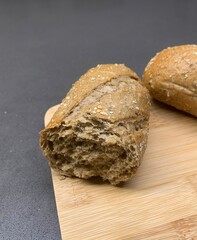 Closeup image of freshly baked wholemeal bread on a wooden chopping board