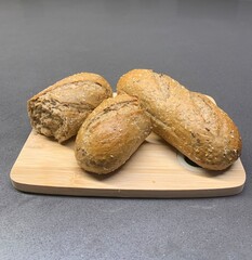 Closeup image of freshly baked wholemeal bread on a wooden chopping board
