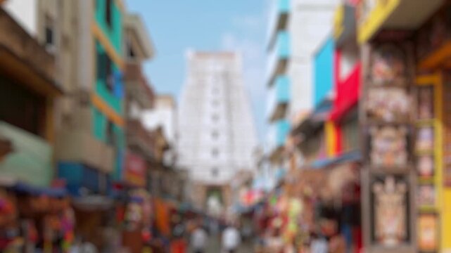 Bokeh view of devotees visit Sri Govinda Raja Swamy Temple in Tirupati, India. Blurred background footage.