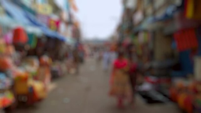 Bokeh view of devotees visit Sri Govinda Raja Swamy Temple in Tirupati, India. Blurred background footage.
