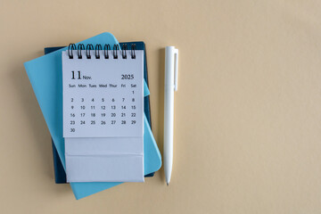 Hello, November 2025. Desktop calendar and notepad for writing on the desktop.