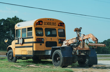 Yellow school bus modified to be a tow truck in a small town in Texas, USA