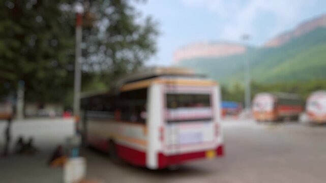 Bokeh view of bus stop near Alipiri Toll Plaza, security check point on the road to Tirumala hill in Tirupati, India. Blurred background footage.