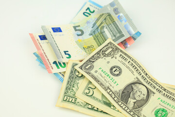Euro and dollar bills on white background