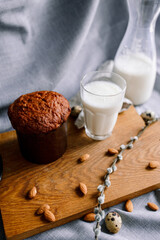 Traditional Easter cakes (kulich) with glaze, nuts, and dried fruits. Rustic still lifes with milk, eggs, willow branches, gift boxes, and festive decorations for Orthodox Easter celebration.