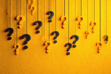 Question marks hanging from strings against a bright yellow background