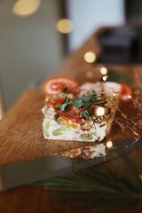 Festive and everyday meals: from waffles and pancakes with jam to salmon, salads, baked chicken, and takeaway food. Seasonal table settings and healthy food in catering or home-style presentation.