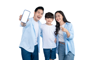 Asian family is smiling and pointing at a mobile phone with a blank screen. They appear joyful and connected in their home life.