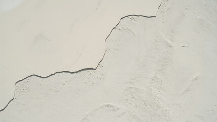 Cracked white surface, textured lines and crevices.
