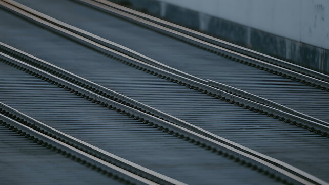 Parallel train tracks on a dark surface.
