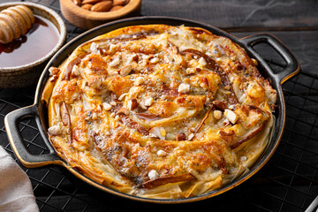 Phyllo pastry pie with pear, gorgonzola cheese, almond and honey close up