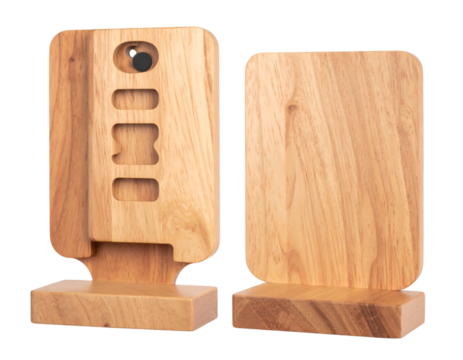 Two wooden smartphone stands with carved details, showcasing natural wood grain and minimalist design for desk accessories on transparent background - Powered by Adobe