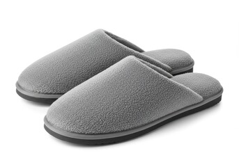 Stylish leather shoes, black and brown, stand next to a comfortable pair of slippers, all isolated on a white background