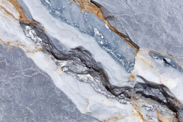 Fototapeta premium Silver veins running through rough gray and blue rock formation