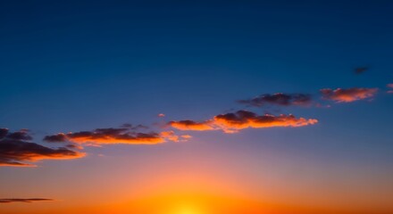 Fototapeta premium Beautiful sunset with orange and blue sky and clouds