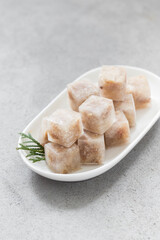 Aspic, Jellied meat in the shape of a small cubes. On a ceramic plate	
