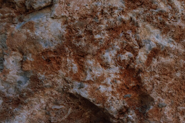 Natural red stone background mineral formation or rock with signs of weathering on surface