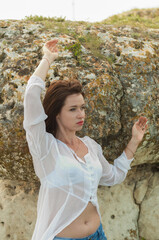 Photo session outdoors of a pretty girl in shorts, a shirt and a dress