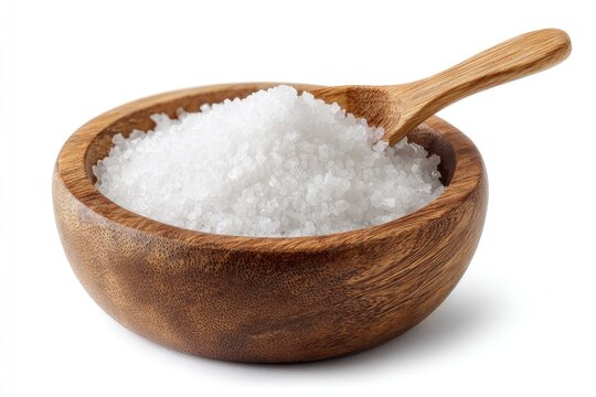 A small wooden bowl brimming with coarse white salt; a wooden spoon rests within, partially submerged in the salt