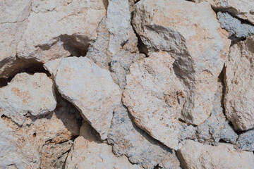 Old natural stone masonry without mortar between the stones, natural background