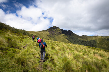 Fototapeta premium Pichincha Province, Quito, Ecuador - July 5, 2025: Hikers climb to the summit of Pasochoa Volcano, in the Pasochoa Wildlife Refuge. It is an extinct volcano, 4,200 meters high.