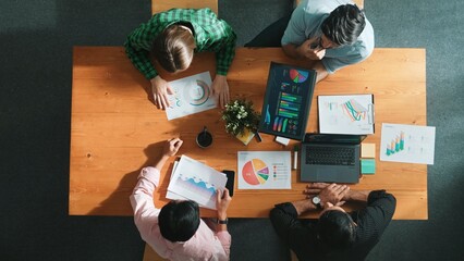 Time lapse of diverse business people working together to analyze chart. Top down aerial view of...