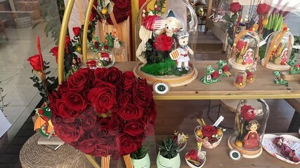 Barcelona, Spain-May 19, 2024. Shop window of a shop selling red rose with an ear of wheat, celebration of Sant Jordi on 23 April in Catalonia, Spain.