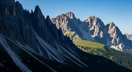 Jagged mountain ridges meeting alpine meadows under clear blue sky sunlight cascade