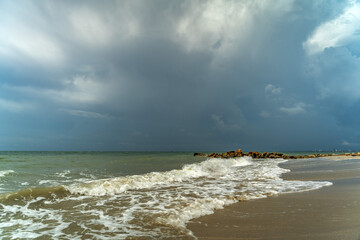 A paradise beach with white sand and waves breaking in the blue sea. copy space