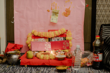 Hindu Ritual Setup: A vibrant display of cultural traditions with flowers, envelopes, money, and offerings arranged for a sacred ceremony.