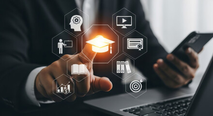 Man interacting with a laptop, pointing to a glowing graduation cap icon surrounded by various educational and business related icons, symbolizing online learning and personal development