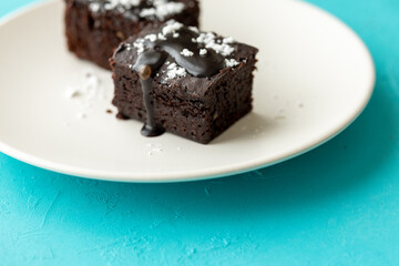 Vegan chocolate brownie on plate close up