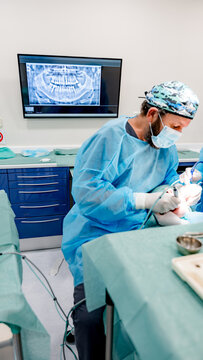 A dentist performs a dental implant procedure in a modern clinic